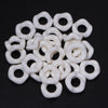 A collection of white acrylic doughnut spacer beads for jewelry making