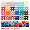 A tray of round silicone beads in various colors and sizes, including pinks, yellows, blues, greens, and browns.