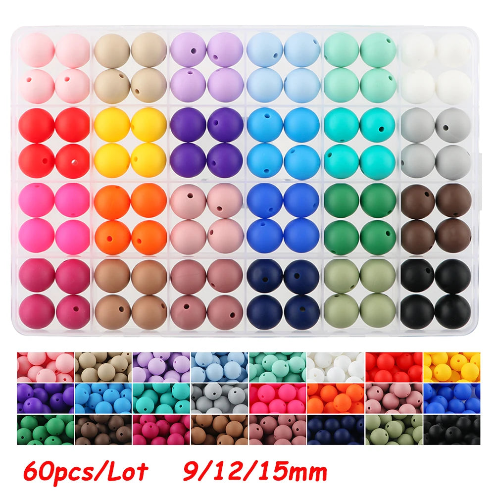 A tray of round silicone beads in various colors and sizes, including pinks, yellows, blues, greens, and browns.