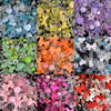 A collection of colorful acrylic beads and charms in various shades including green, yellow, orange, pink, purple, and clear.