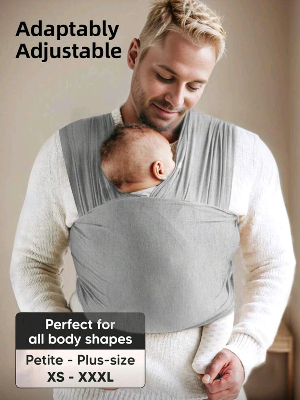 A man is wearing a grey knitted fabric baby carrier while holding a baby, demonstrating its adjustable fit for various body s