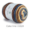 Spool of gradient rainbow cotton-wool yarn showing various shades of brown, blue, and cream.