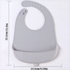 A gray waterproof silicone baby bib with a catch pocket shown from above.