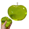 A bright green squishy apple shaped fidget toy with a stick, being held in a hand.
