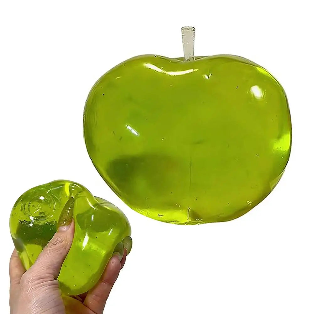 A bright green squishy apple shaped fidget toy with a stick, being held in a hand.