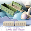 A set of plastic building tools for a little wall mason featuring green and beige pieces on a blue background.