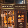 A wooden miniature kit of a magic wand shop display featuring various items and a sign.