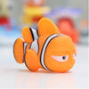 An orange rubber baby bath toy resembling a fish with black stripes, shown in a close-up.