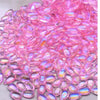 A close-up view of pink water drop Czech glass beads for jewelry making