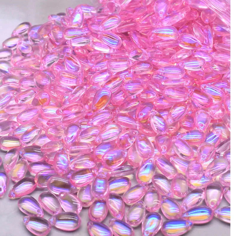 A close-up view of pink water drop Czech glass beads for jewelry making