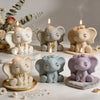 A collection of three elephant silicone molds in white, blue, and purple used for candle soap and resin crafts.