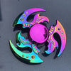 A vibrant iridescent rainbow metal fidget spinner featuring a central sphere and surrounding wing-like blades.
