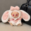 A plush rabbit costume for a doll featuring pink and white fluffy fur and long ears.