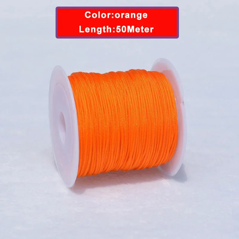 Orange nylon knotting cord for jewelry making, 50 meters long and wound on a spool.