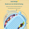 A close-up of a blue magnetic doodle board for kids filled with colorful beads and a pen, demonstrating a sealed design.
