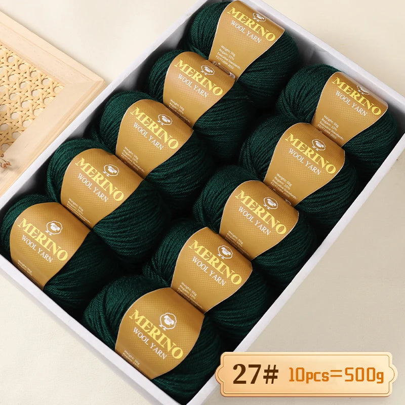 A box of dark green Merino wool yarn balls with yellow labels, packaged for knitting projects.