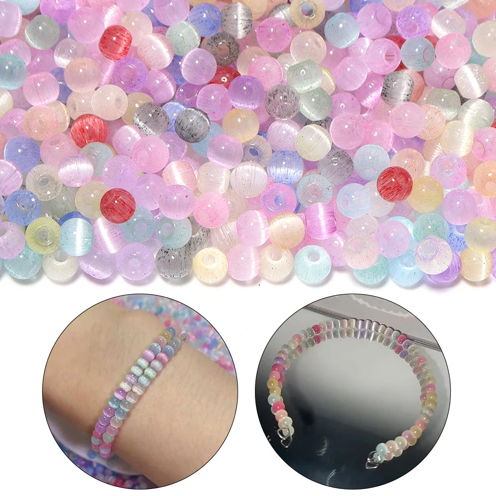 A close-up view of colorful 4mm cat eye glass beads mixed in various shades for jewelry making.