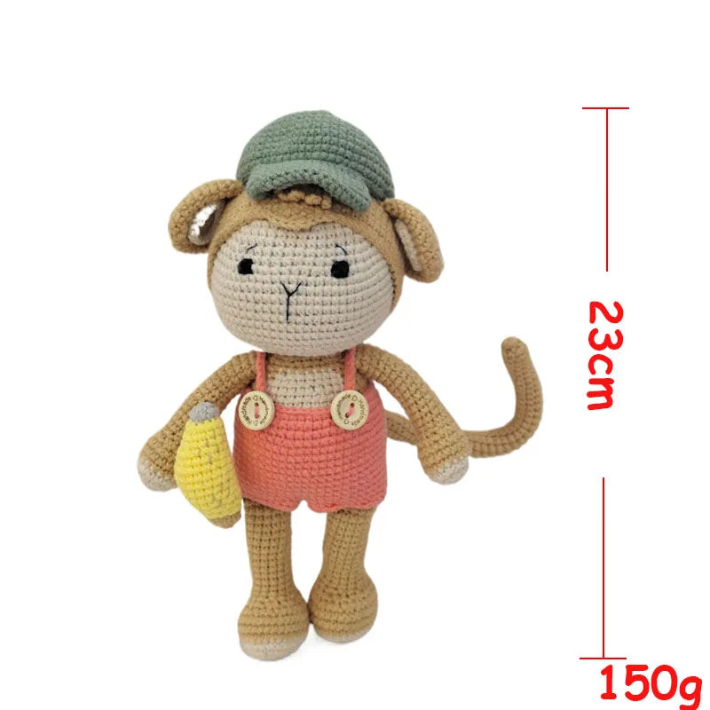 Handmade crochet stuffed bear toy with a green cap and yellow accessory, shown against a white background.