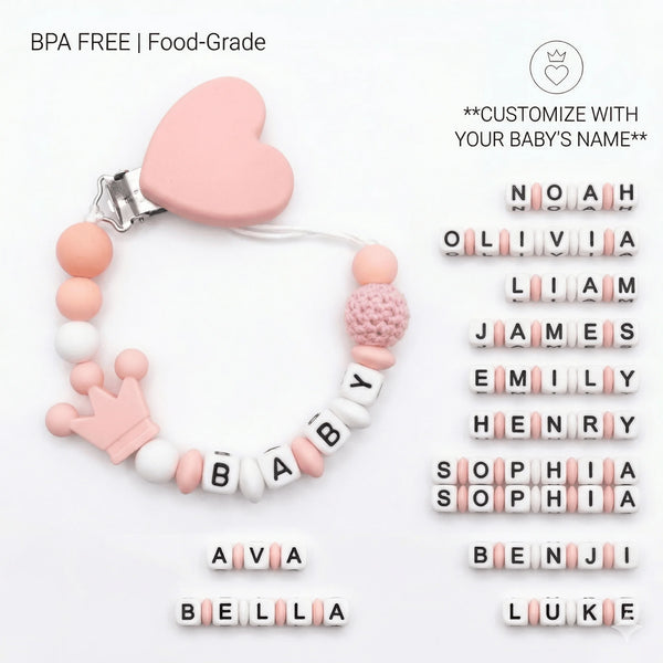 A pink silicone pacifier clip bracelet featuring various baby names spelled out in small white and pink letters.