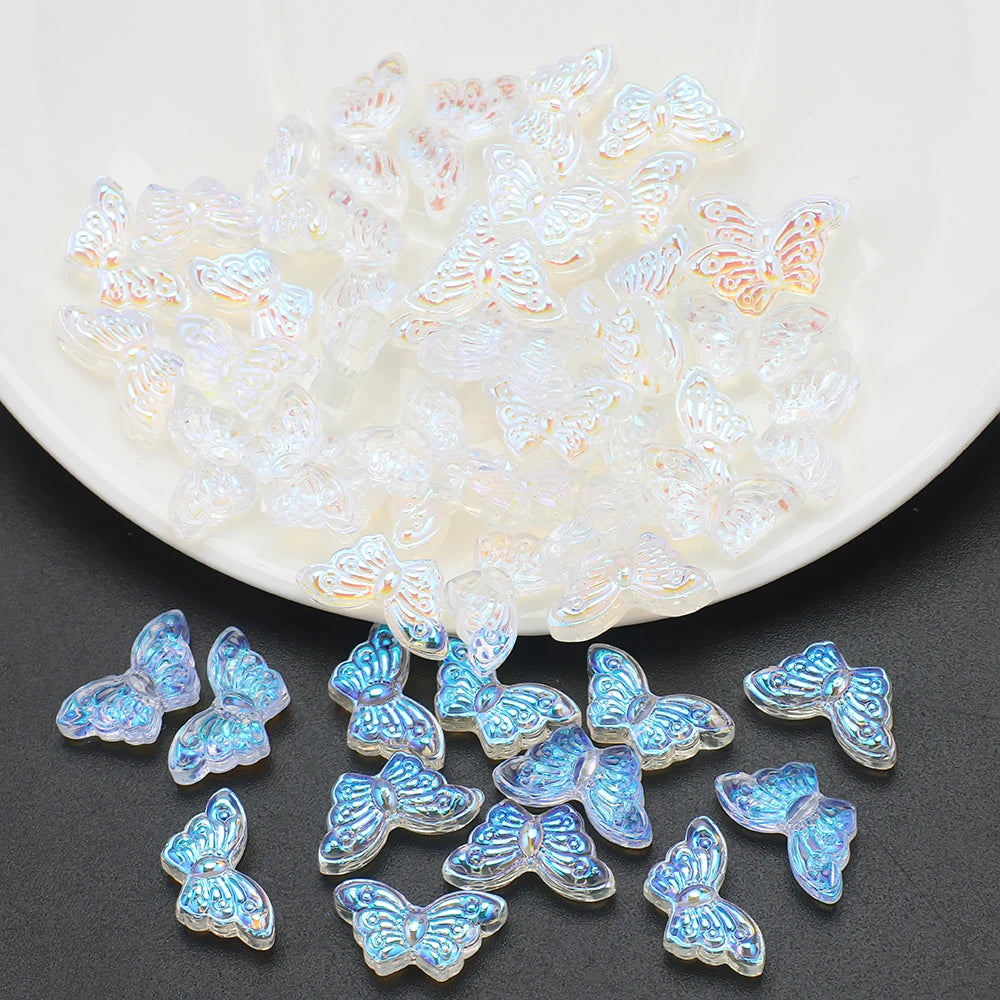 A pile of iridescent, translucent butterfly glass beads for jewelry making.
