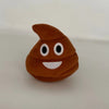 A brown, squishy-looking plush toy shaped like a piece of poop with white eyes and a smiling mouth.