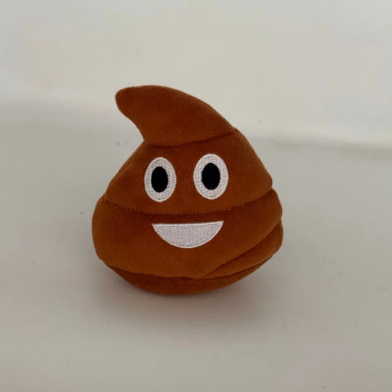A brown, squishy-looking plush toy shaped like a piece of poop with white eyes and a smiling mouth.