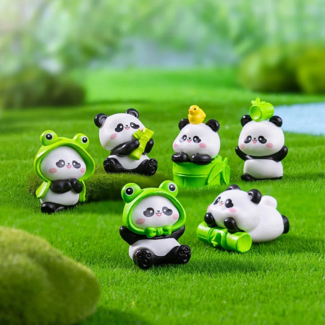 A set of adorable resin panda figurines in various colors and poses displayed on green artificial grass.