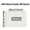 A box of a 300 piece puzzle measuring 38cm by 26cm.