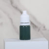 A small dark green bottle of water marbling paint art kit for kids with a white cap
