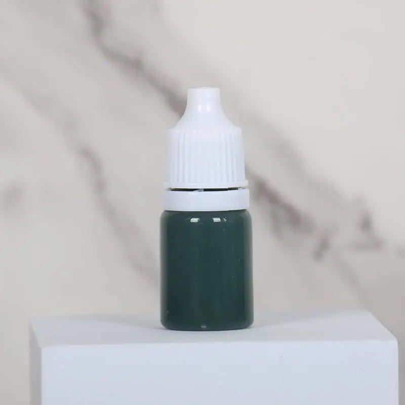 A small dark green bottle of water marbling paint art kit for kids with a white cap