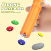 An orange magnetic pen is shown next to various colored magnetic components like green, red, blue, and gray.