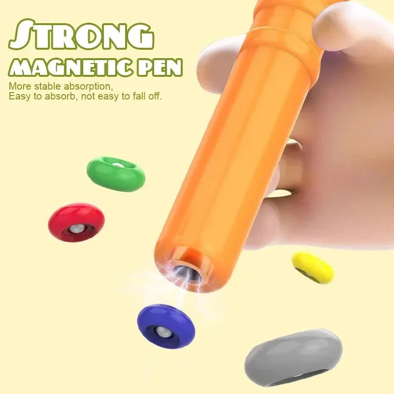 An orange magnetic pen is shown next to various colored magnetic components like green, red, blue, and gray.