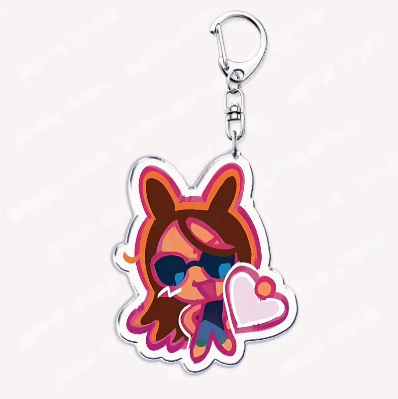 Acrylic keychain featuring a chibi-style character with brown hair, goggles, and a heart detail.