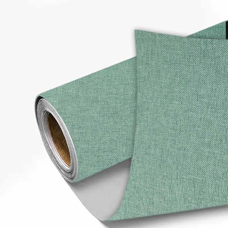 A roll of light sage green linen book binding cloth used for albums and scrapbooks.
