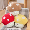 A pair of cute mushroom plush toys in red and yellow with white spots resting on a checkered fabric surface.