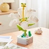 A set of rose flower building blocks featuring white petals and a yellow stem, displayed on a wooden table.