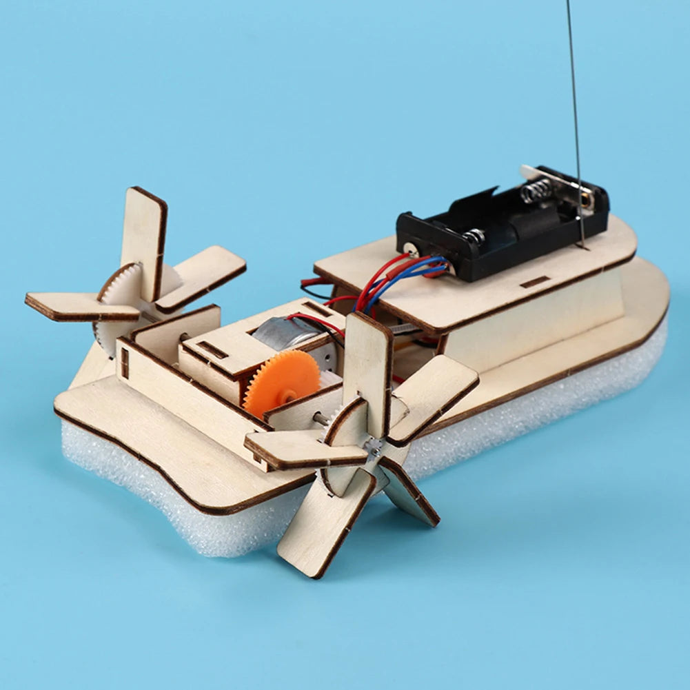 A wooden paddle boat model built from wood and plastic components for a DIY STEM science kit.