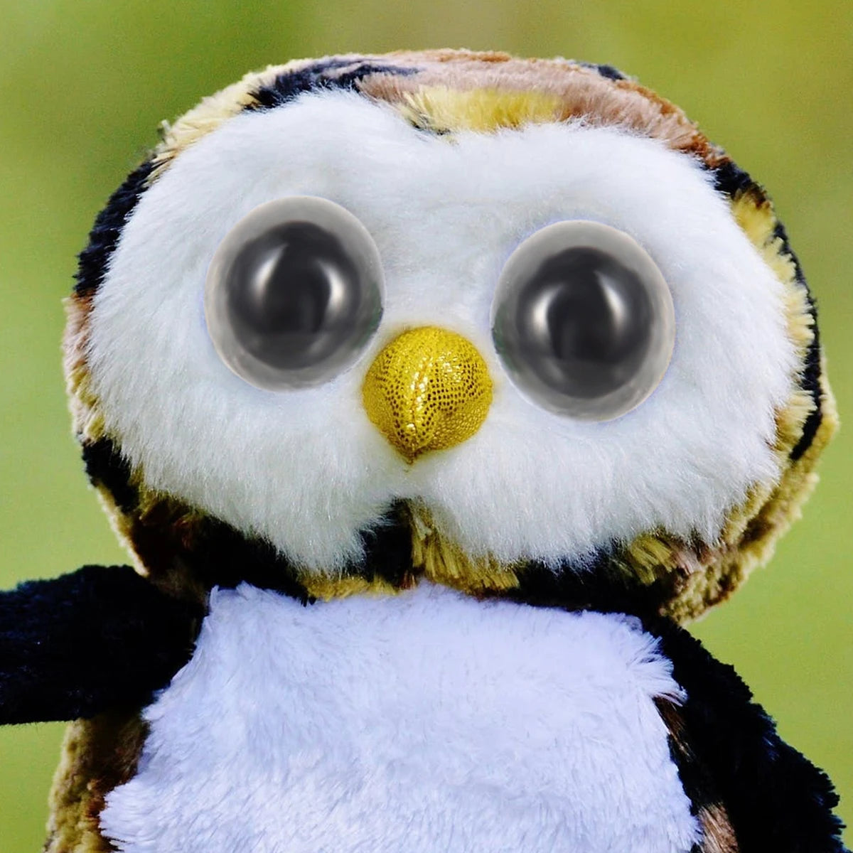 A plastic safety eyes and nose set for dolls and stuffed animals featuring large, round eyes and a yellow nose.