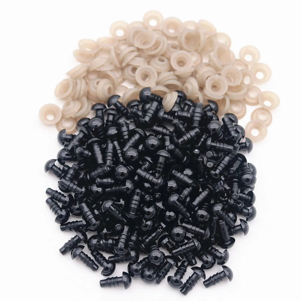 A pile of black plastic safety eyes with washers for crafting and stuffed animals