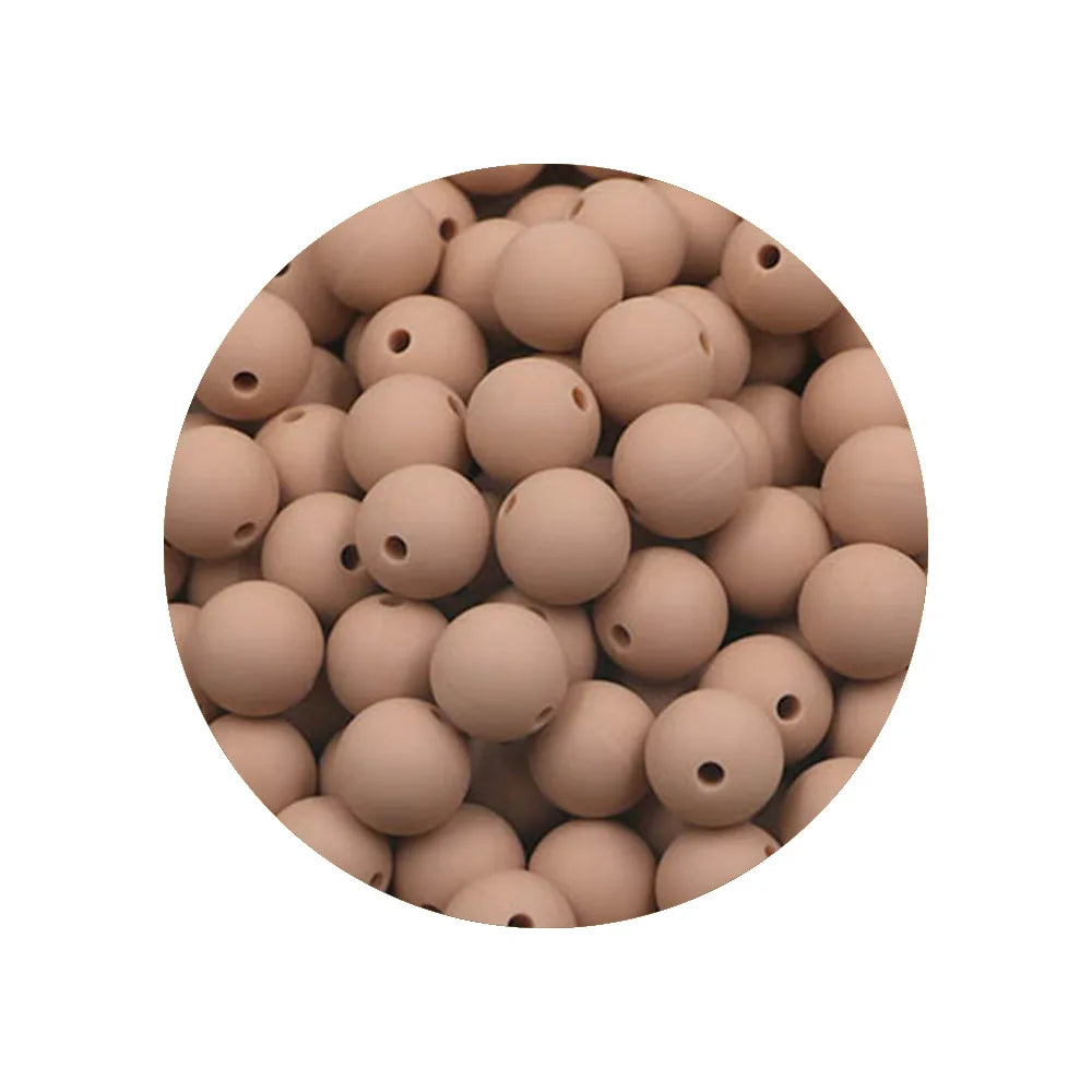 A pile of assorted silicone beads in a natural beige or tan color.