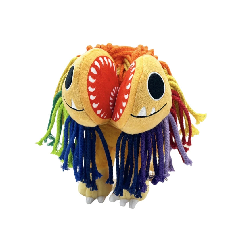 A plush toy of a lion with orange and yellow yarn hair and large teeth