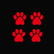 A set of three red dog paw print vinyl stickers on a black background.