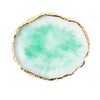 A round, translucent green resin piece with a natural, irregular edge and a thin gold trim.