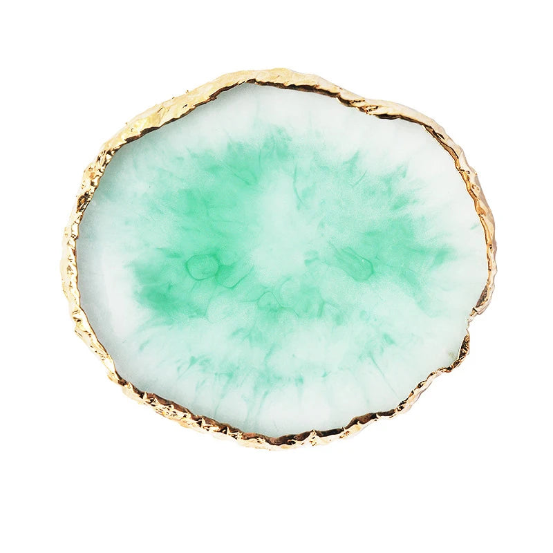 A round, translucent green resin piece with a natural, irregular edge and a thin gold trim.