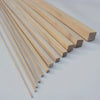 A row of natural light wood strips, approximately 250mm long, laid diagonally on a white surface.
