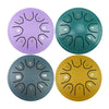 Four colored steel tongue drums with mallets arranged in a square formation
