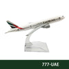 A diecast model of an Emirates Boeing airplane in white and green livery.