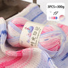 Three balls of pink and purple gradient acrylic yarn for knitting and crochet