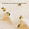 Close-up of a white breathable and sweat absorbing fabric with yellow floral embroidery.