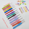 A collection of ergonomic crochet hooks, stitch markers, and needles in various colors and sizes laid out on a white surface.